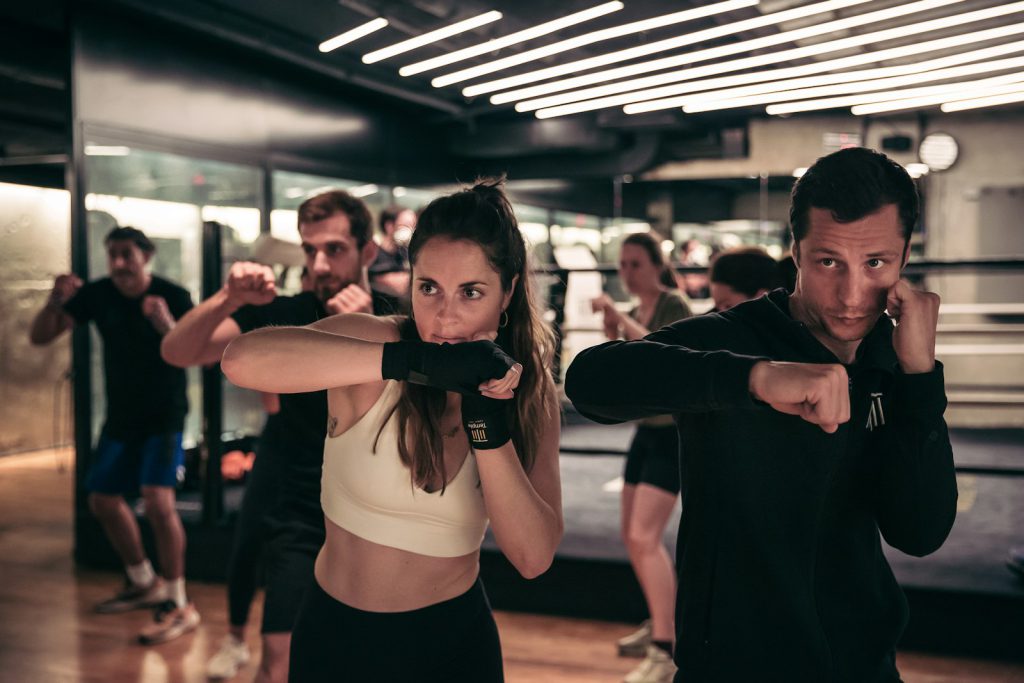 A man and a woman standing in a gym